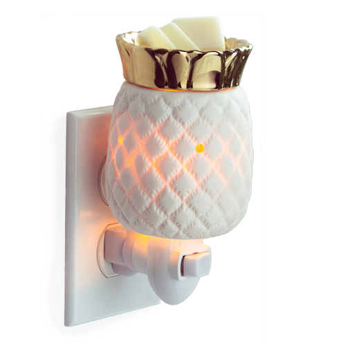Pineapple shaped candle warmer.  Item is white ceramic with an internal glow, and topped with golden metallic fronds.  