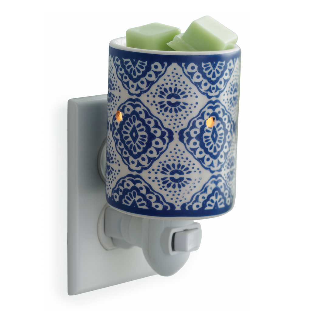 Indigo and white cylinder candle warmer plugged into an outlet