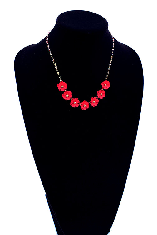 Seven red matte flowers linked together with gold detail on a 6" chain with 3" extender