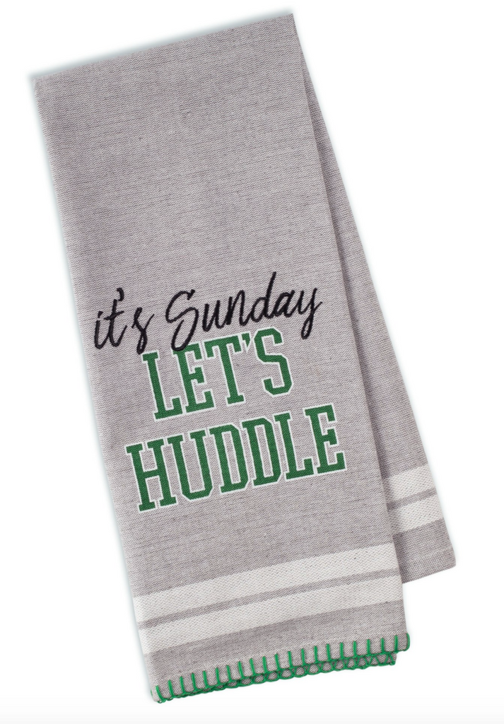 A gray dishtowel on a white background.  The towel is folded so on the front can be seen.  In black embroidered text it says 'It's Sunday'.  Below it in green font it says 'let's huddle'.  The towel also features two horizontal white stripes along the bottom, and green hoop stitching along the hem.
