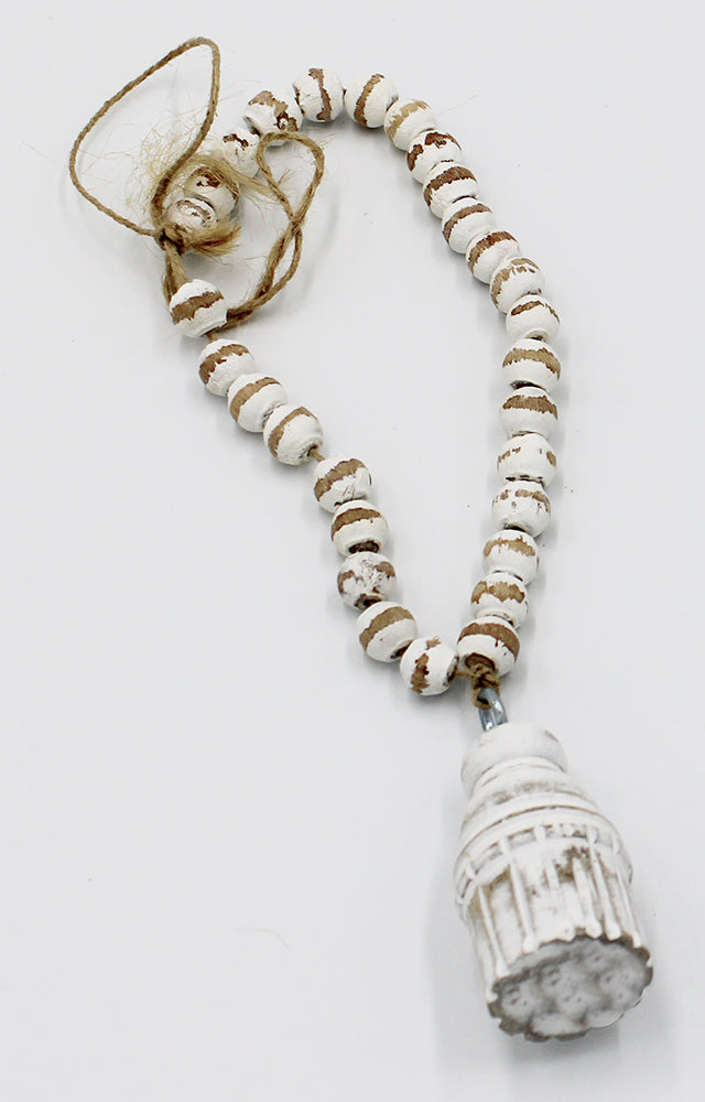 A short closed loop of white wooden beads with a wooden tassel, and twine loop for hanging.  