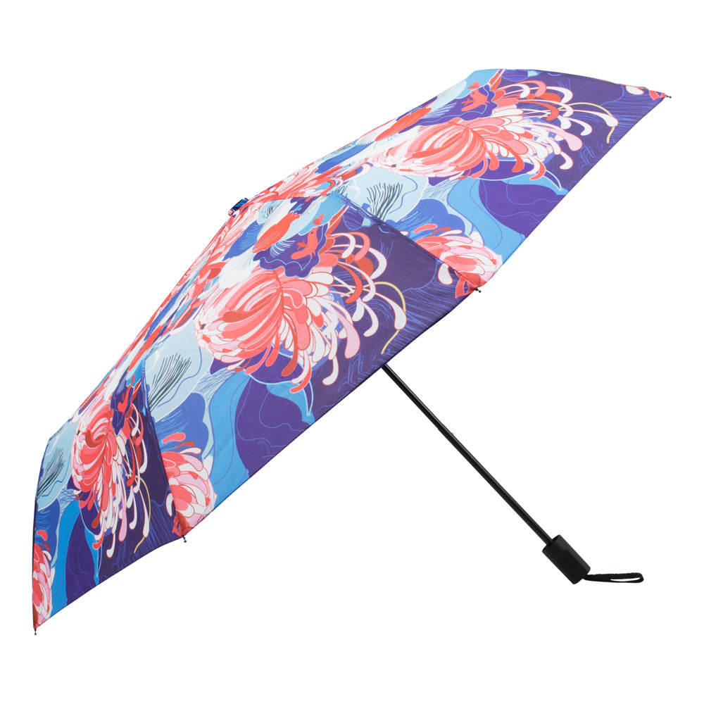 An open umbrella with a colorful pattern of pink, red and white flowers on a blue and indigo background.