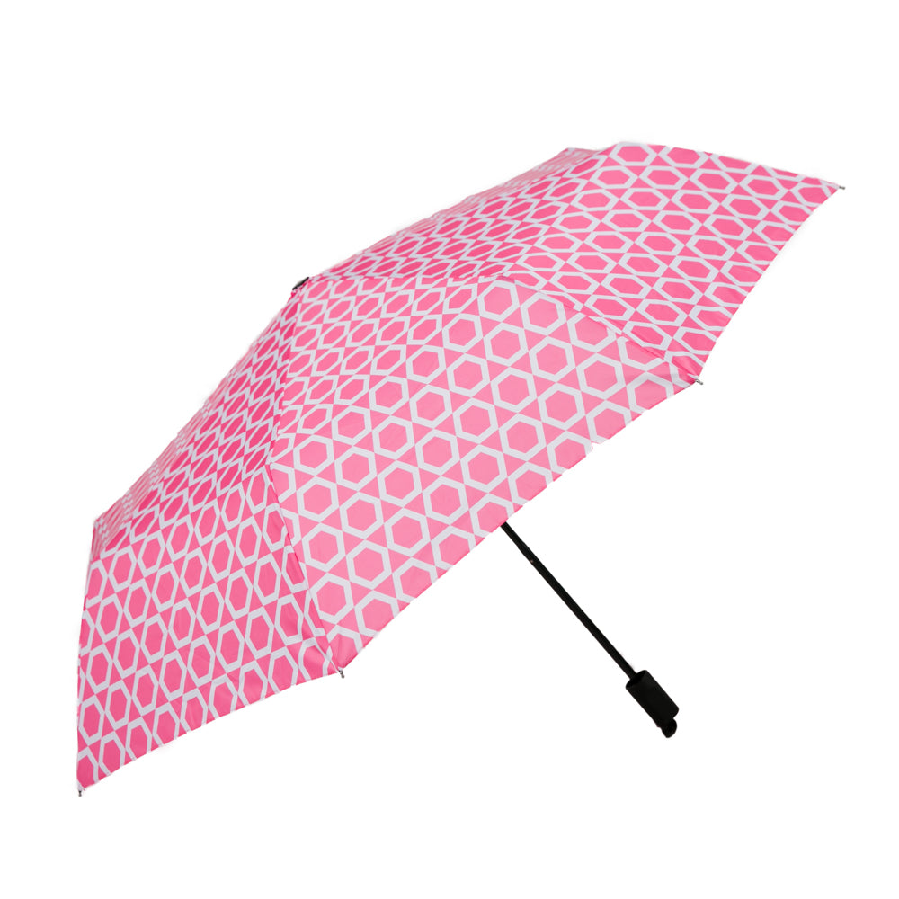 An open umbrella with a pattern of white hexagons on a hot pink background.