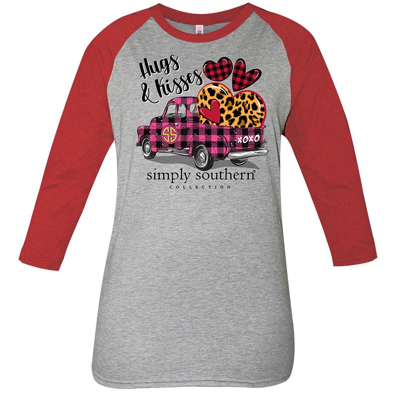Gray t-shirt with red long sleeves.  Image printed on shirt is of a pink and black plaid truck with a variety of plaid and leopard hearts in the back.  Text above the truck says 'Hugs and Kisses'.  Text below the truck says 'simply southern collection'