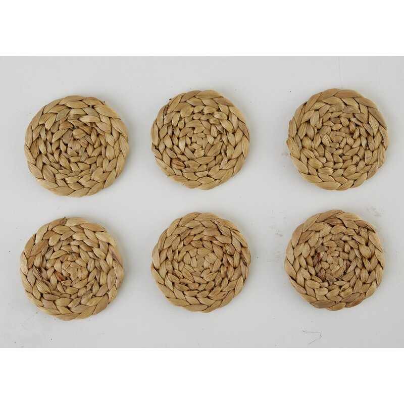 Six water hyacinth woven coasters on a white background