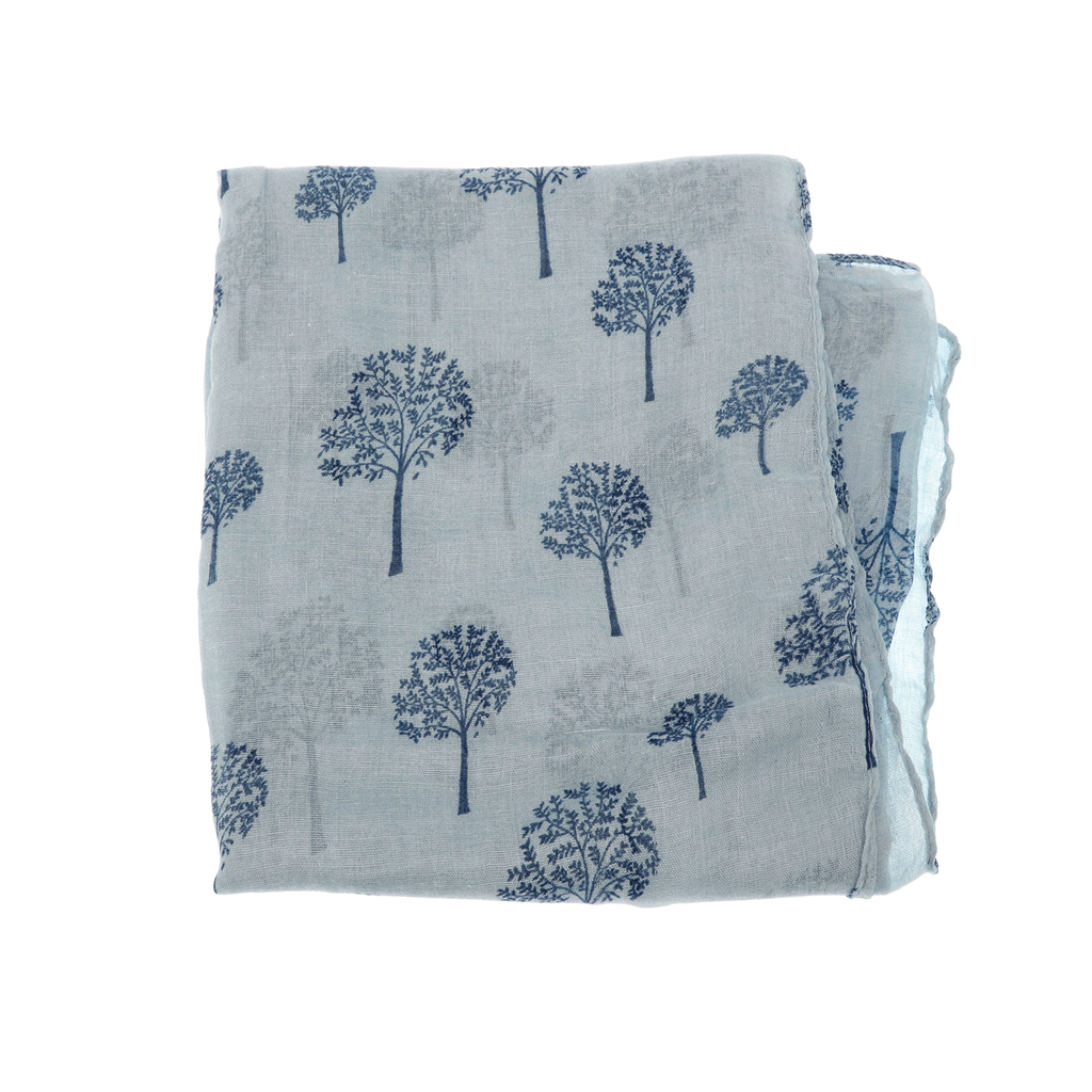 a closeup of A light-blue chambray scarf with printed trees