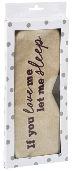 A velvet sleeping mask in a windowed polka dot cardboard box.  The mask inside is off white with embroidered maroon text that says 'If you love me let me sleep.'  
