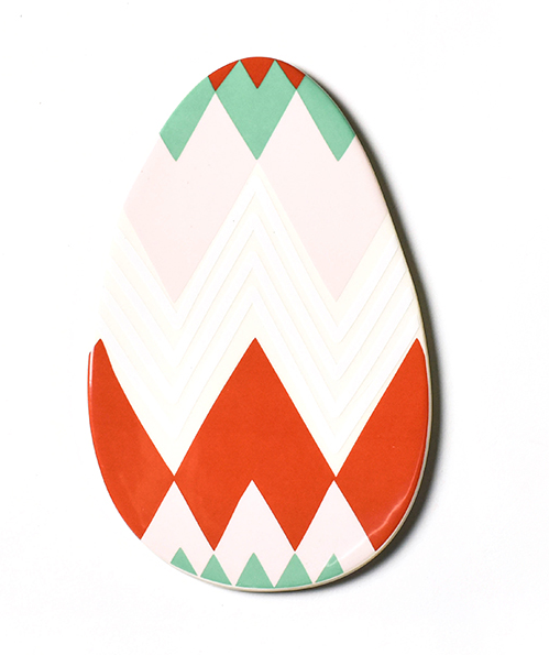 A flat ceramic cut out of an easter egg.  The egg is painted with a modern diamond pattern in red, teal, pink and white.