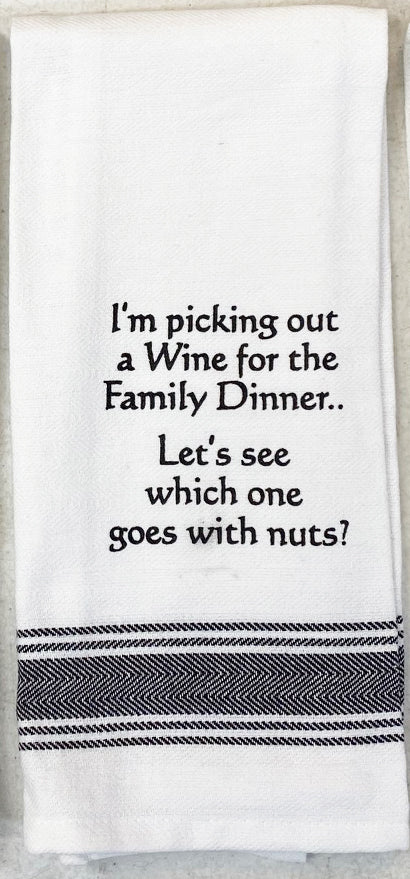 White flour sack tea towel with black printed lettering that reads "I'm picking out a Wine for the Family Dinner... Let's see which one goes with nuts?"