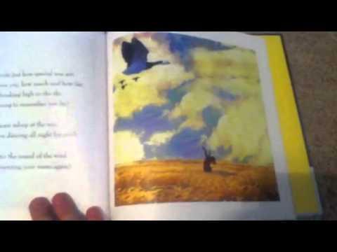 Open book to a page of a person in a field of wheat with a flock of geese flying in a cloudy sky.